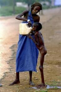 A starving Somali child is given water in Baidoa December 15, 1992. REUTERS/Yannis Behrakis 